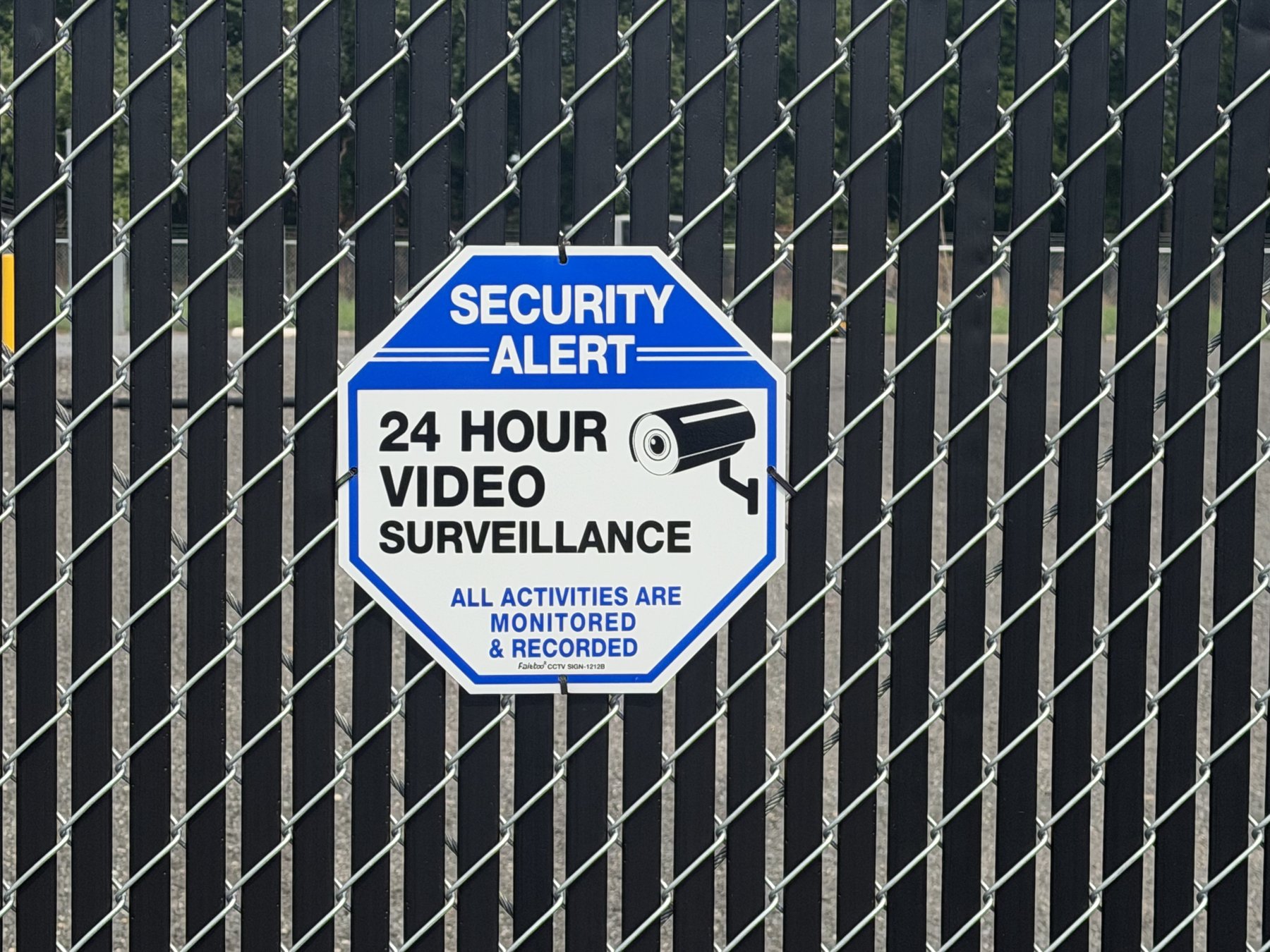 24-hour video surveillance signage on the security fence at A Box's Cambridge storage facility