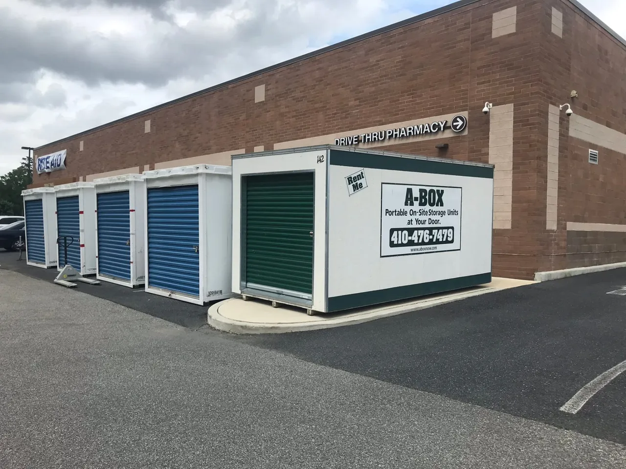 A Box storage container beside rows of blue portable units at a Rite Aid drive-thru pharmacy near Cambridge, Maryland