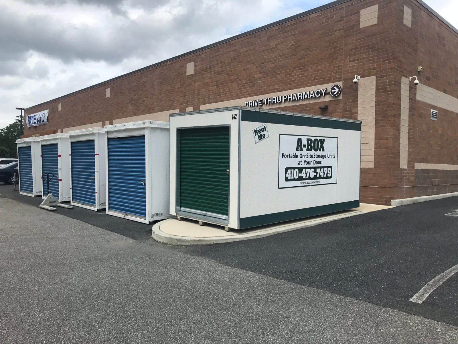 A Box storage container beside rows of blue portable units at a Rite Aid drive-thru pharmacy near Cambridge, Maryland