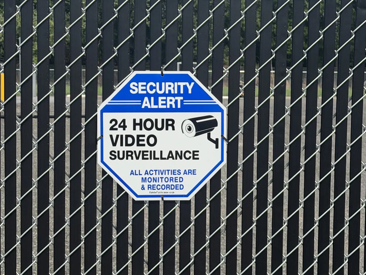 24-hour video surveillance signage on the security fence at A Box's Cambridge storage facility